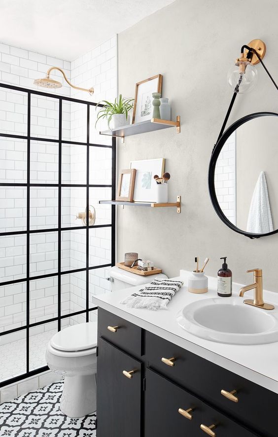 Black and white bathroom  with gold plumbing fixtures