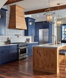 Natural wood accents on kitchen island, stove hood and rafters