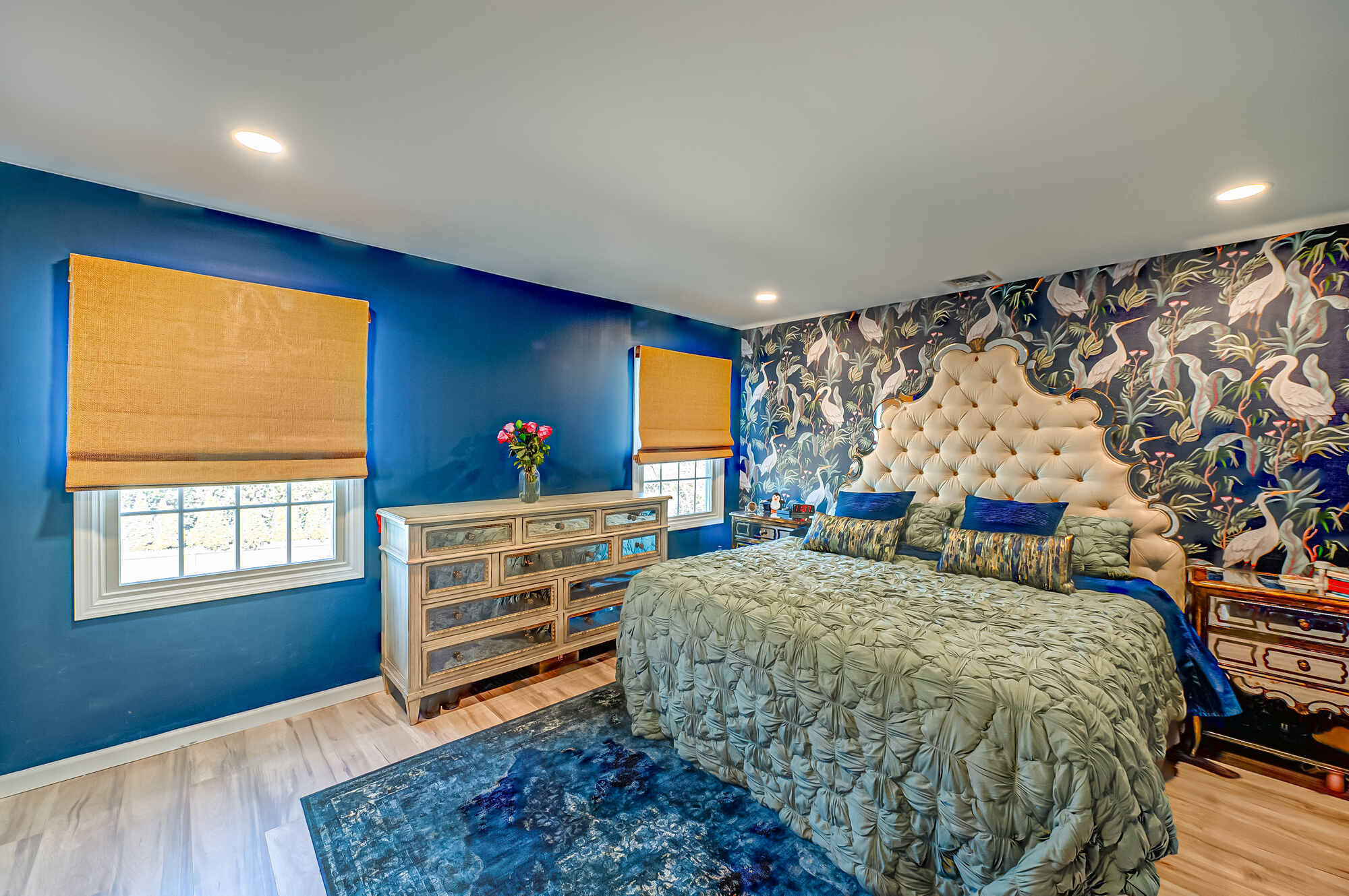 Bold bedroom with navy walls and patterned wallpaper in a custom home by Long Island Creative Contracting, Inc. in Miller Place, NY