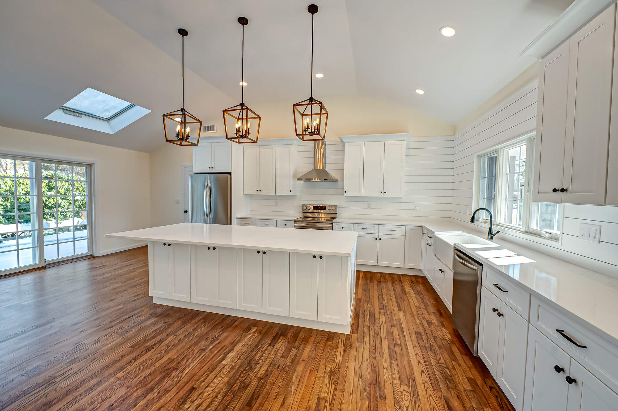 Custom kitchen design featuring a large island and skylight by Long Island Creative Contracting in Stony Brook, NY