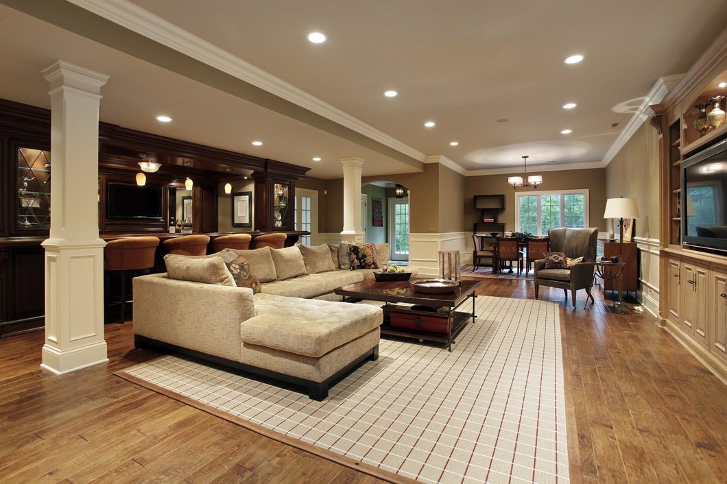Luxury basement featuring bar area and access to back patio