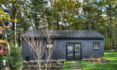 REsized outdoor farm style shed finished with a black metal roof contemporary dark gray siding surrounded by green lawn Dix Hills New York.pdf_1