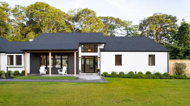 Ranch style Modern Farmhouse- Black roof shingles and white board and baton siding